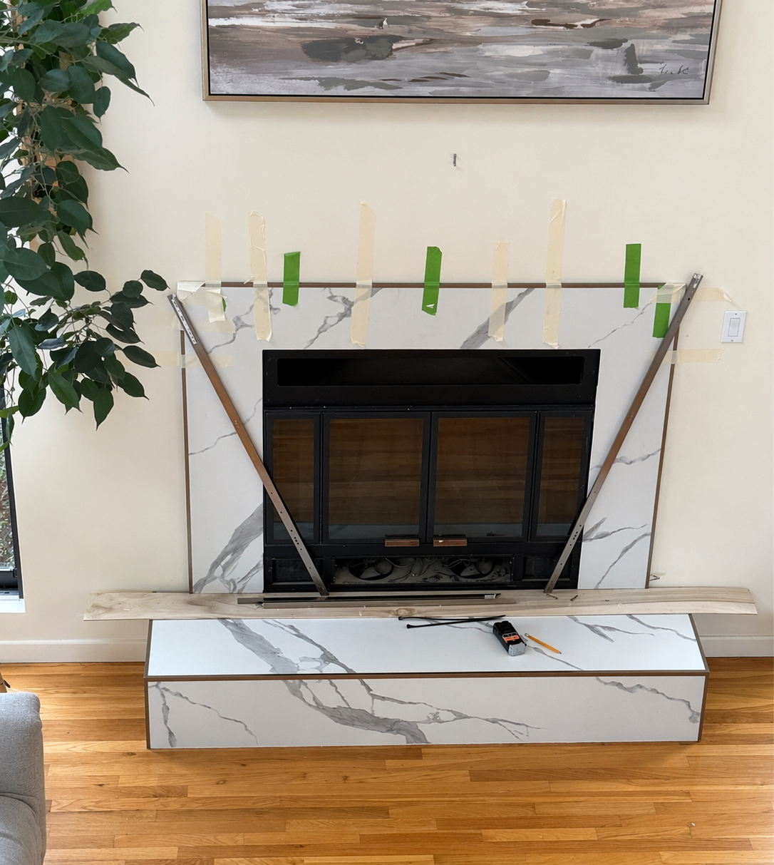 Large-format porcelain slabs being installed on fireplace