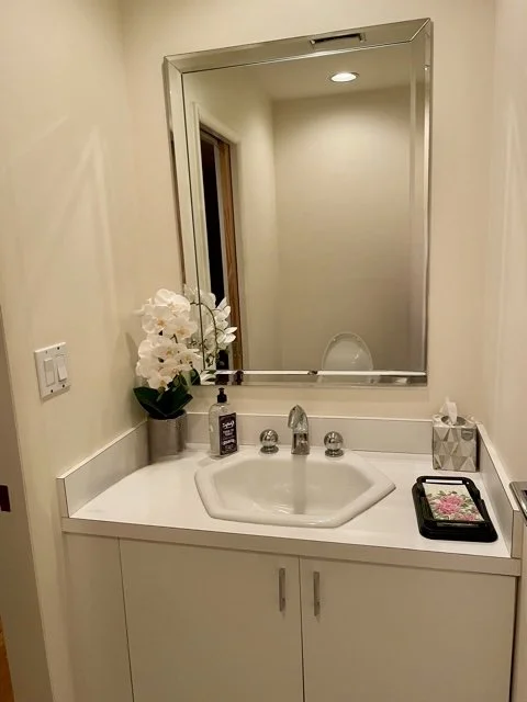 Dated powder room before renovation, vanity wall