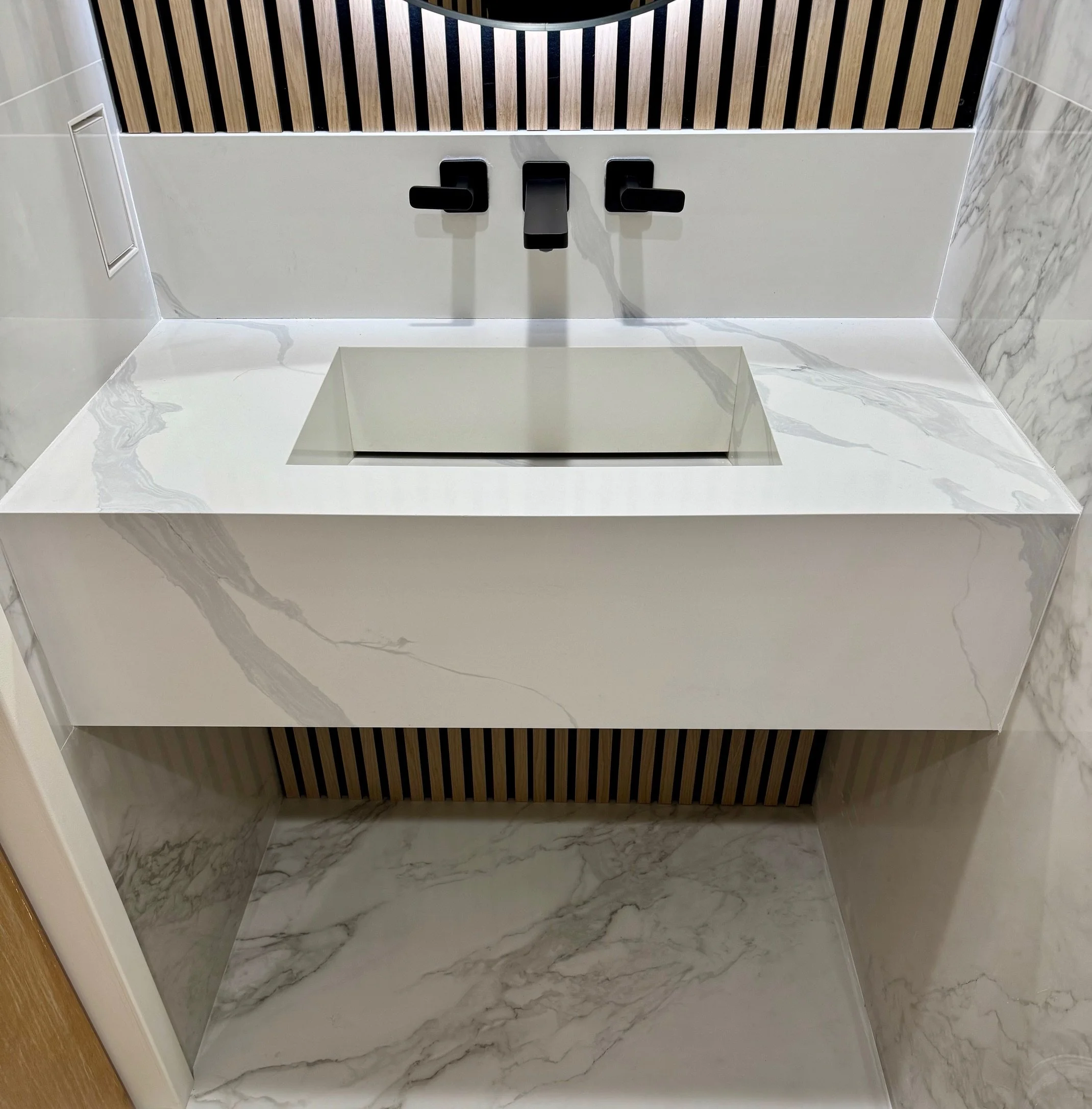 Custom quartz stone sink with Kohler matte black wall-mounted faucet