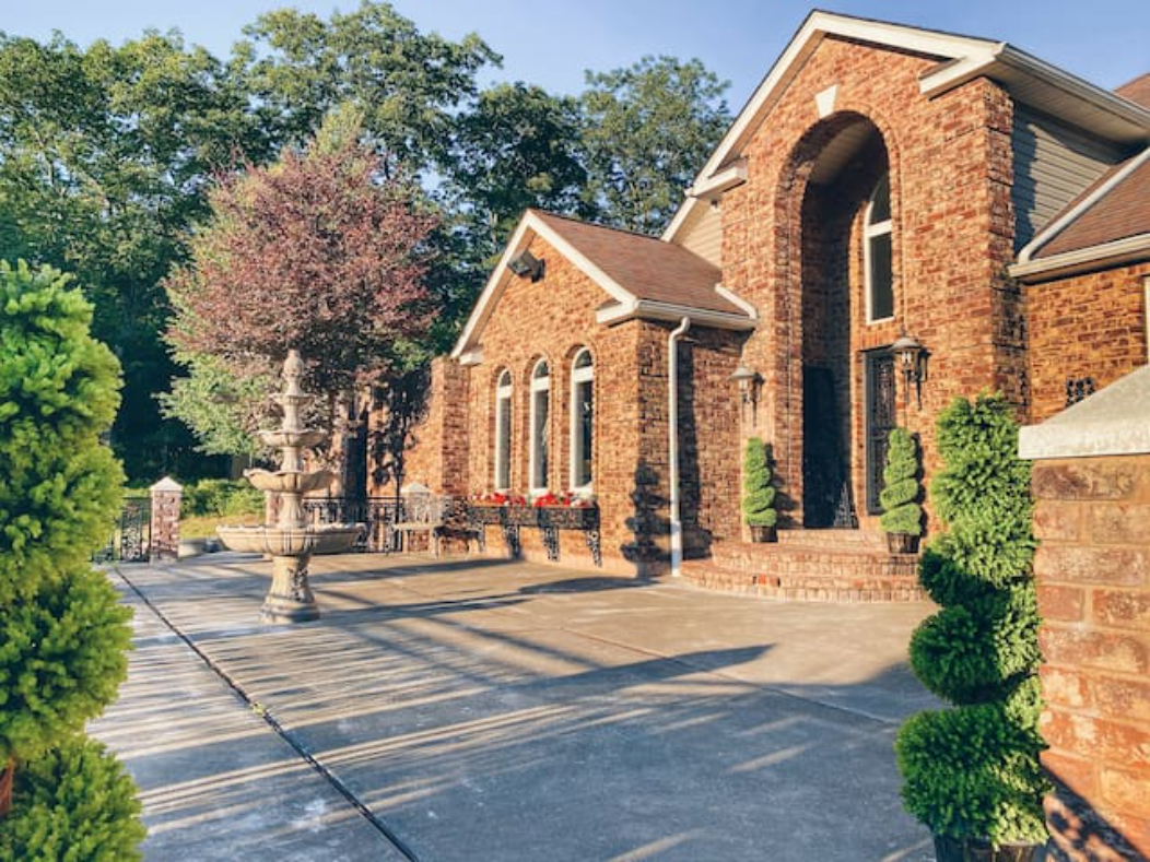 Italian villa-style home in the Poconos, 2007 construction, with brick exterior and tiered fountain