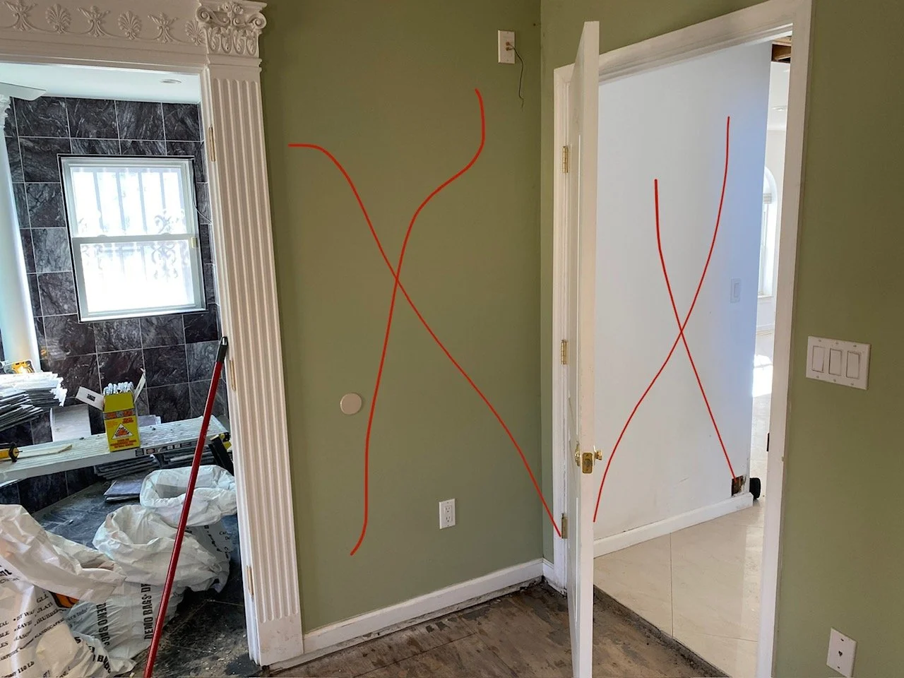 Wall marked with red X pattern indicating wall that needs to come down