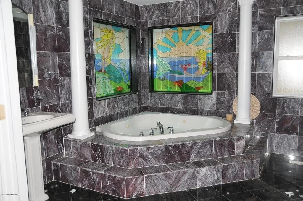 Original 2007 master bath: corner jacuzzi with mermaid stained glass windows