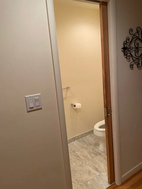 Dated powder room before renovation, looking in