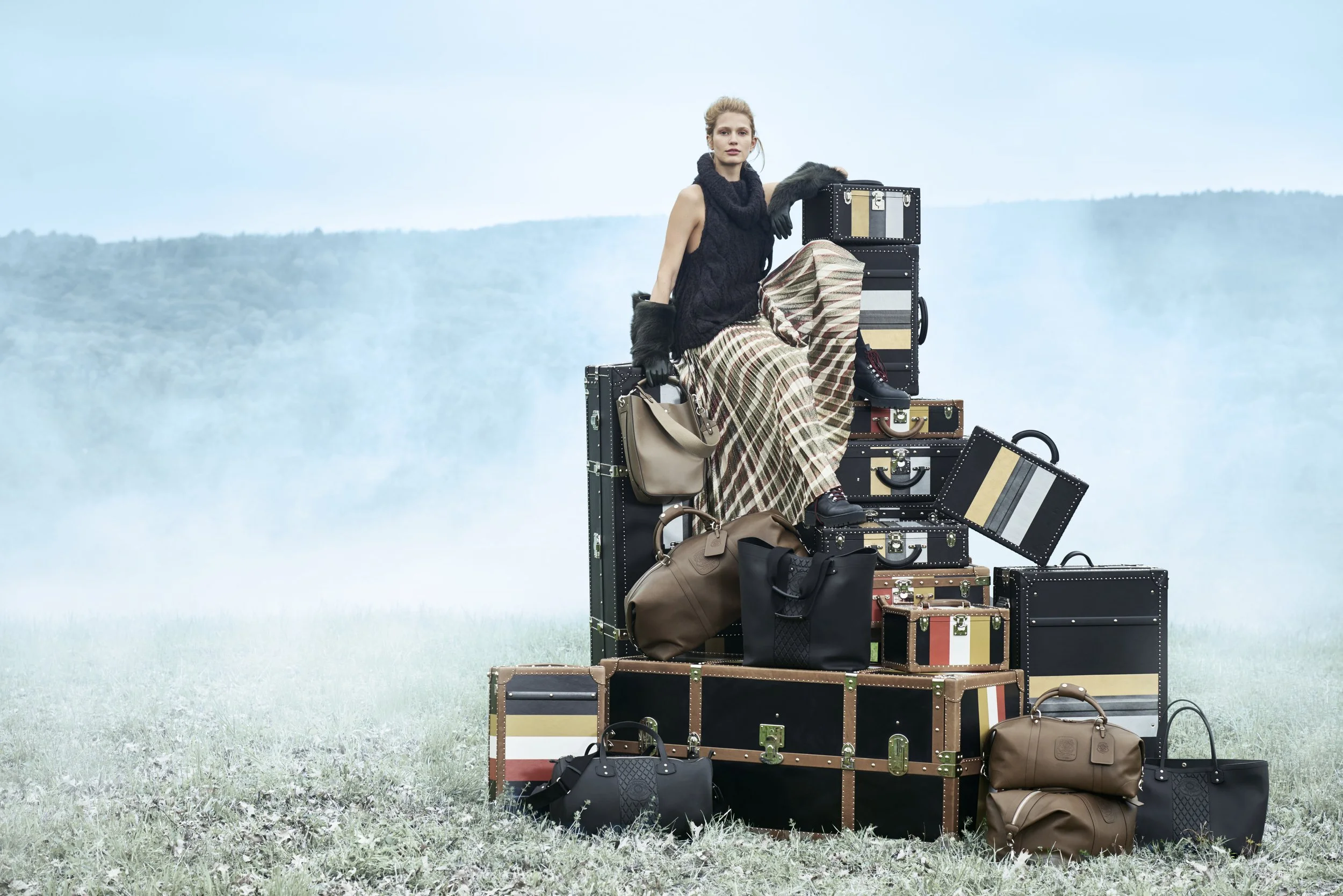 Ghurka luxury leather goods campaign with trunks and bags in misty landscape, art direction by Alexander Mann