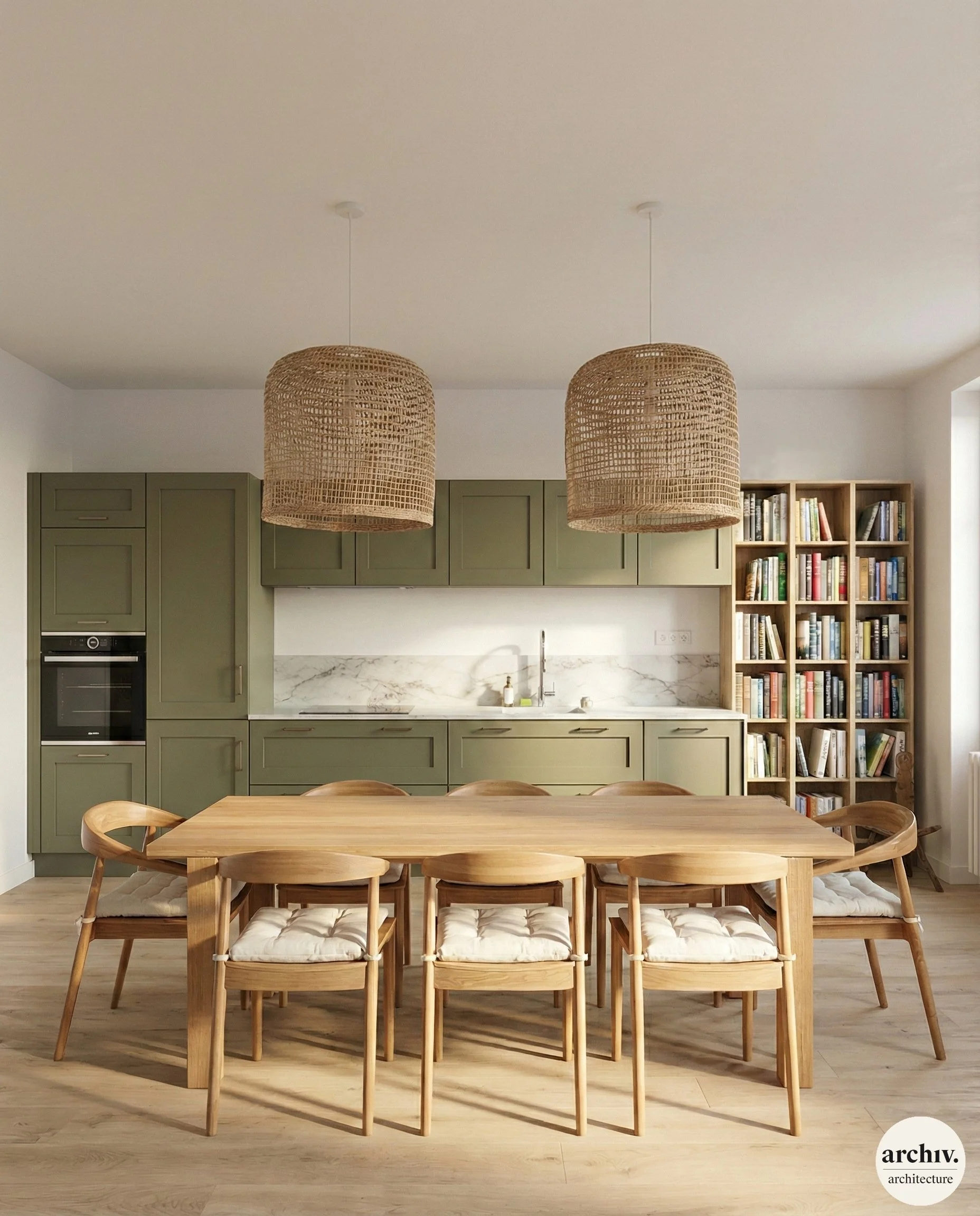 Modern open kitchen and dining area with a wooden dining table, six wooden chairs with cushions, green upper and lower cabinets, a marble backsplash, a bookcase with books, woven pendant lights, and hardwood flooring. Royan.