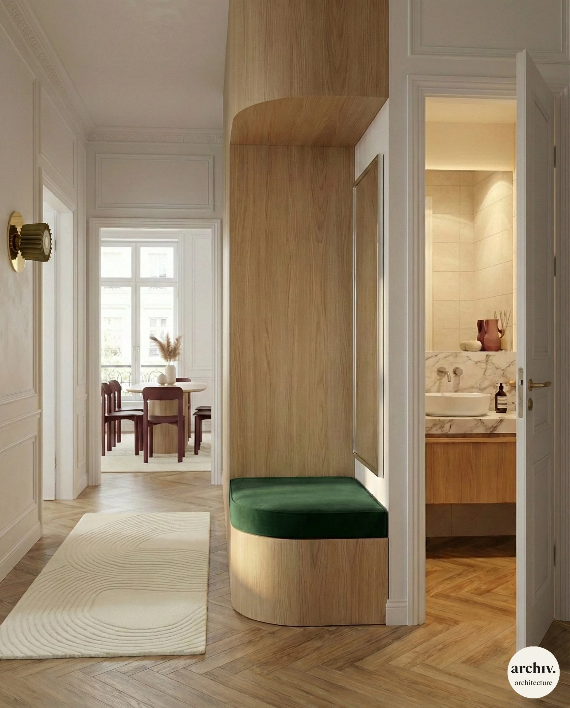 Interior view of a hallway with white walls, wooden flooring, and a built-in bench with green cushion; leading to a dining room in the background with a white table and chairs, and a small bathroom in a haussmann flat. Paris.