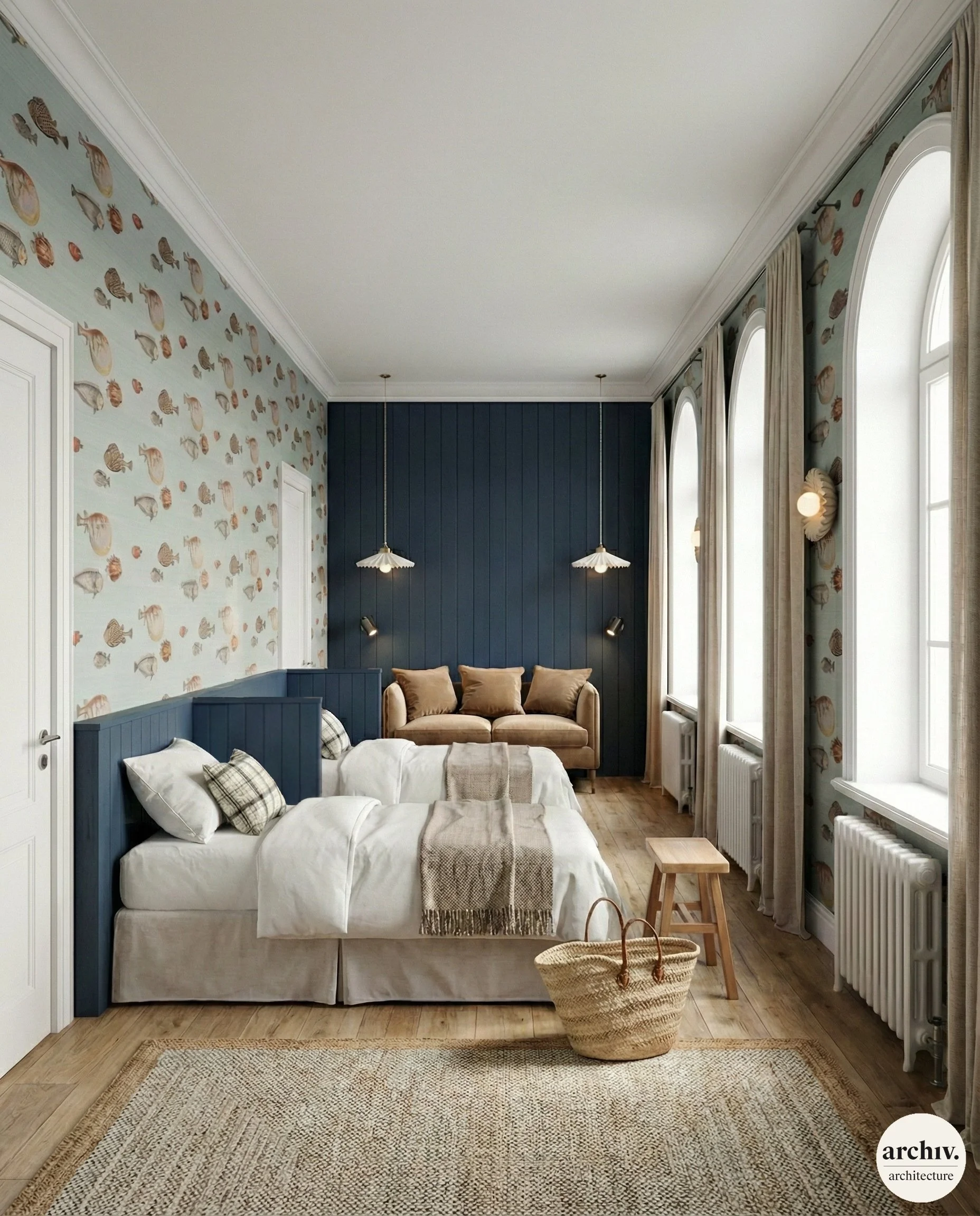 A bedroom with two beds, a beige sofa at the end, and large arched windows with curtains, decorated with sea shell wallpaper, wood flooring, and vintage lighting fixtures.  Bretagne.