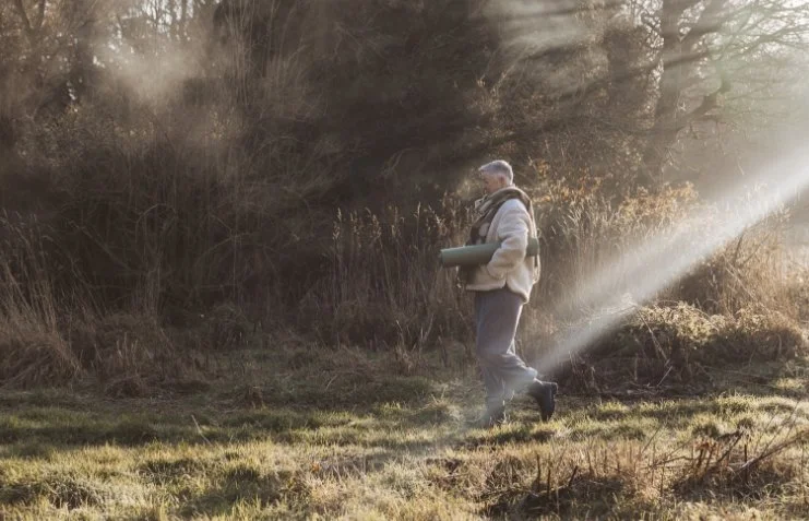 Stephanie walking in the mist to the yurt in great missenden to teach yoga