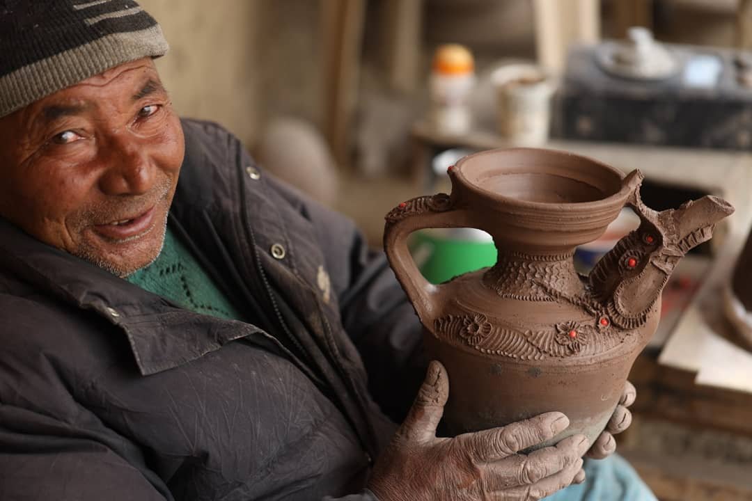 Likir Pottery - Abbale Lamchung Tsepail holding a Tibril teapot
