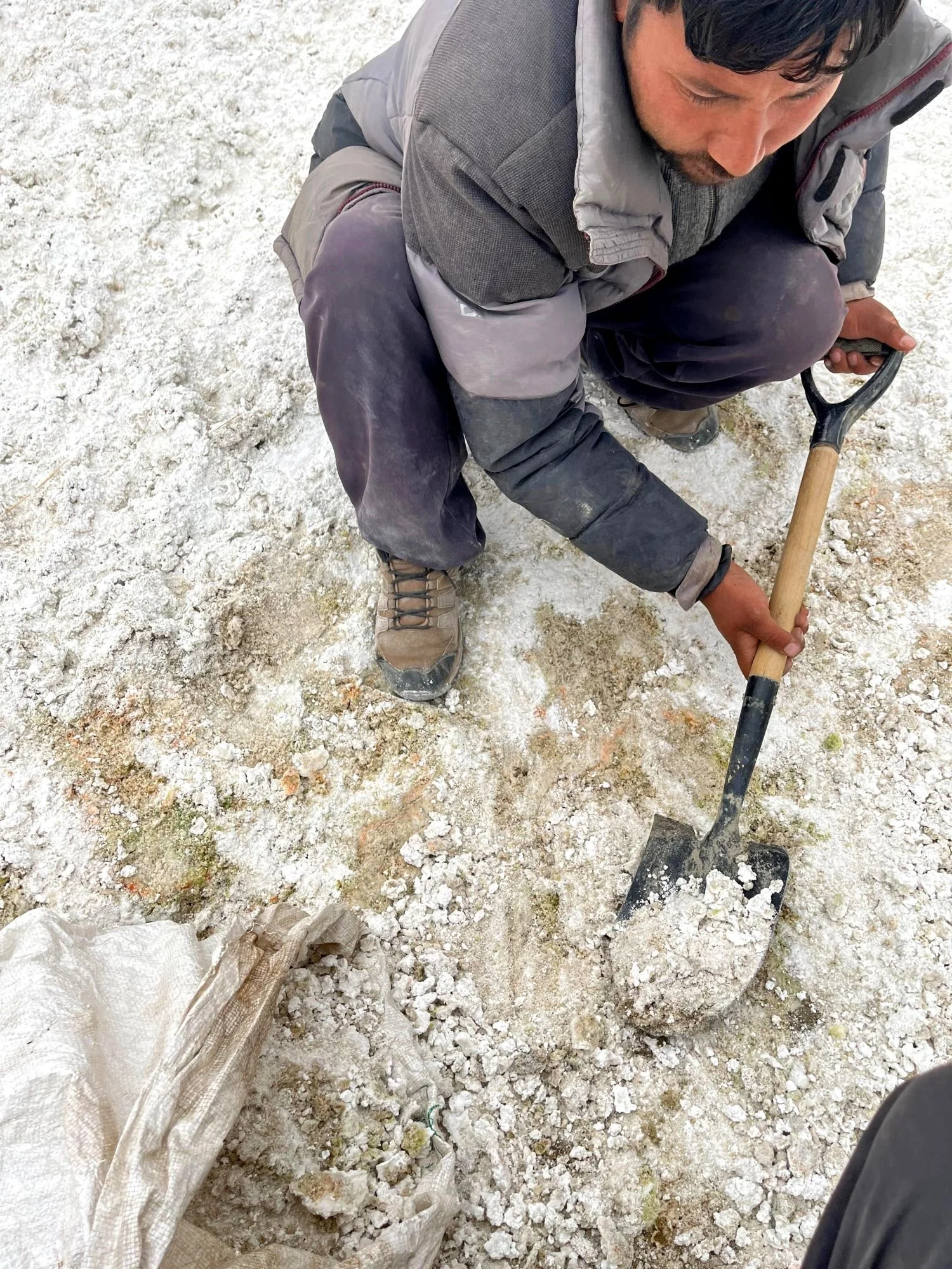 Rigzen shoveling the Glaze into a sack