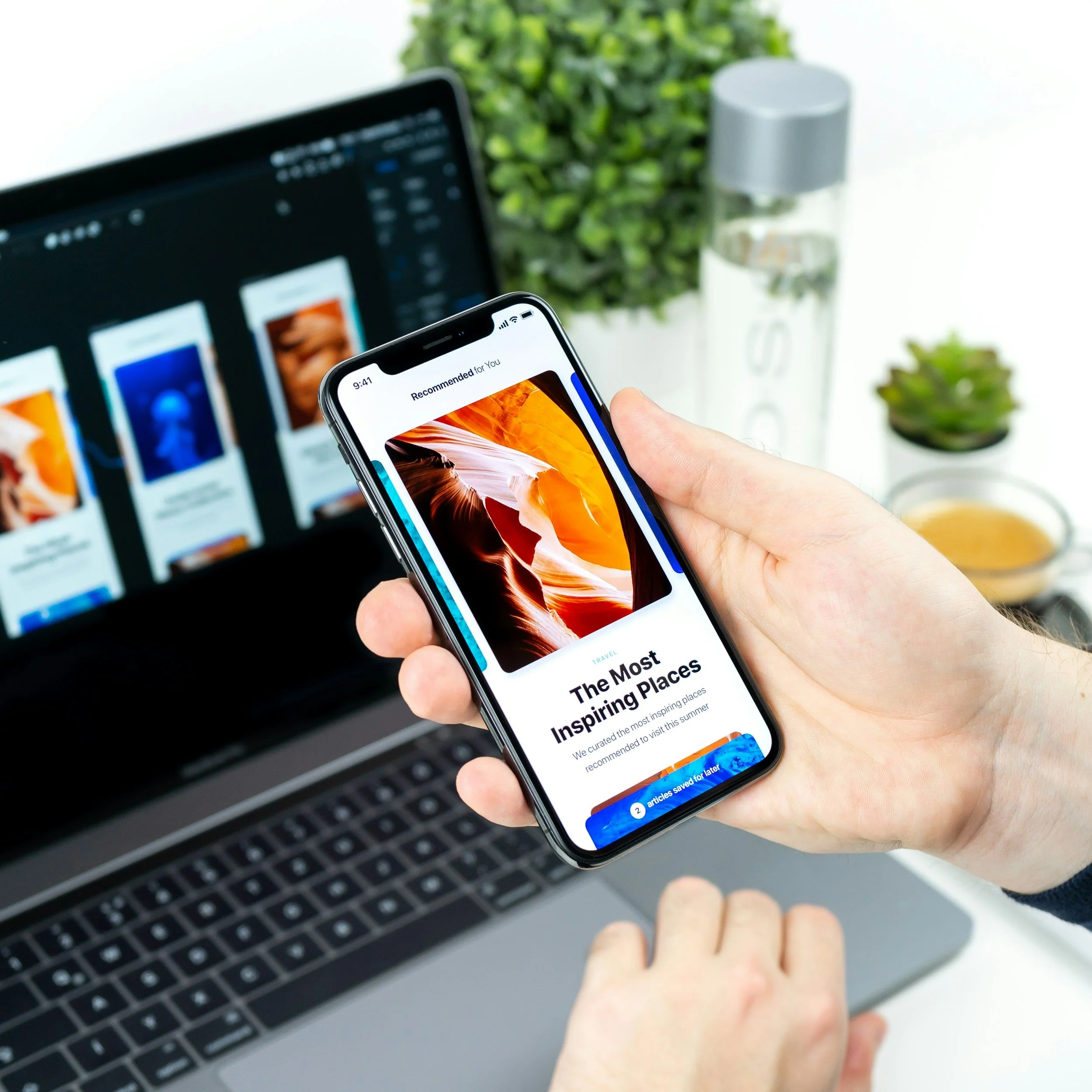 A person holding a mobile phone displaying a mobile-optimised email newsletter template next to an open laptop computer, representing Roza Marketing email and sms marketing services.