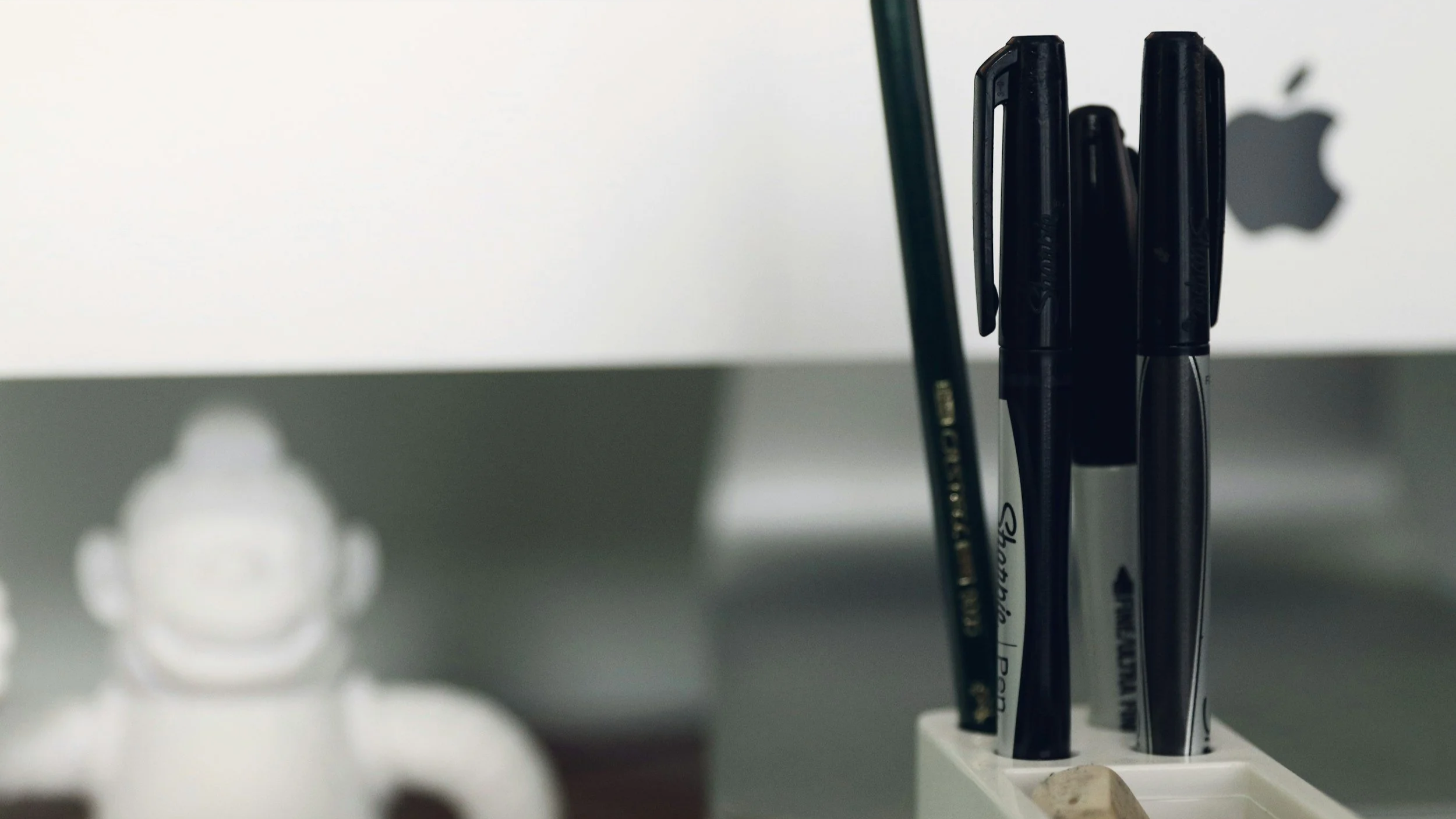 Close up view of desk office supplies and marker pens, representing professional marketing platform management and strategy support by Roza Marketing.