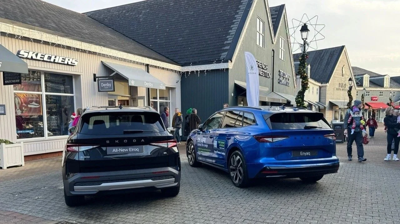 Two Skoda vehicles displayed outside of a shopping centre