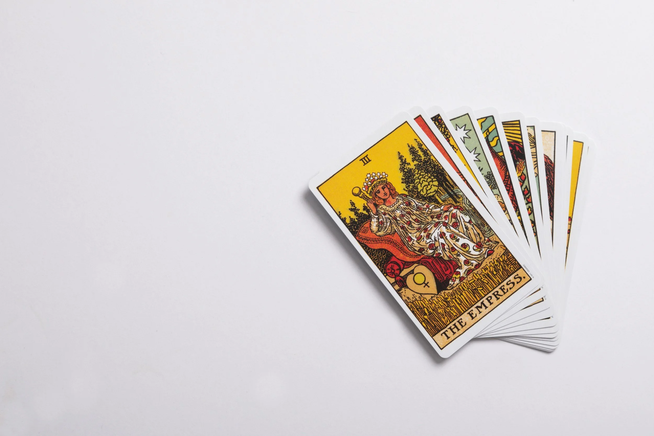 A stack of tarot cards fanned out. The Empress is the card on top. Tarot is used as a career coaching tool in Ashley's practice.