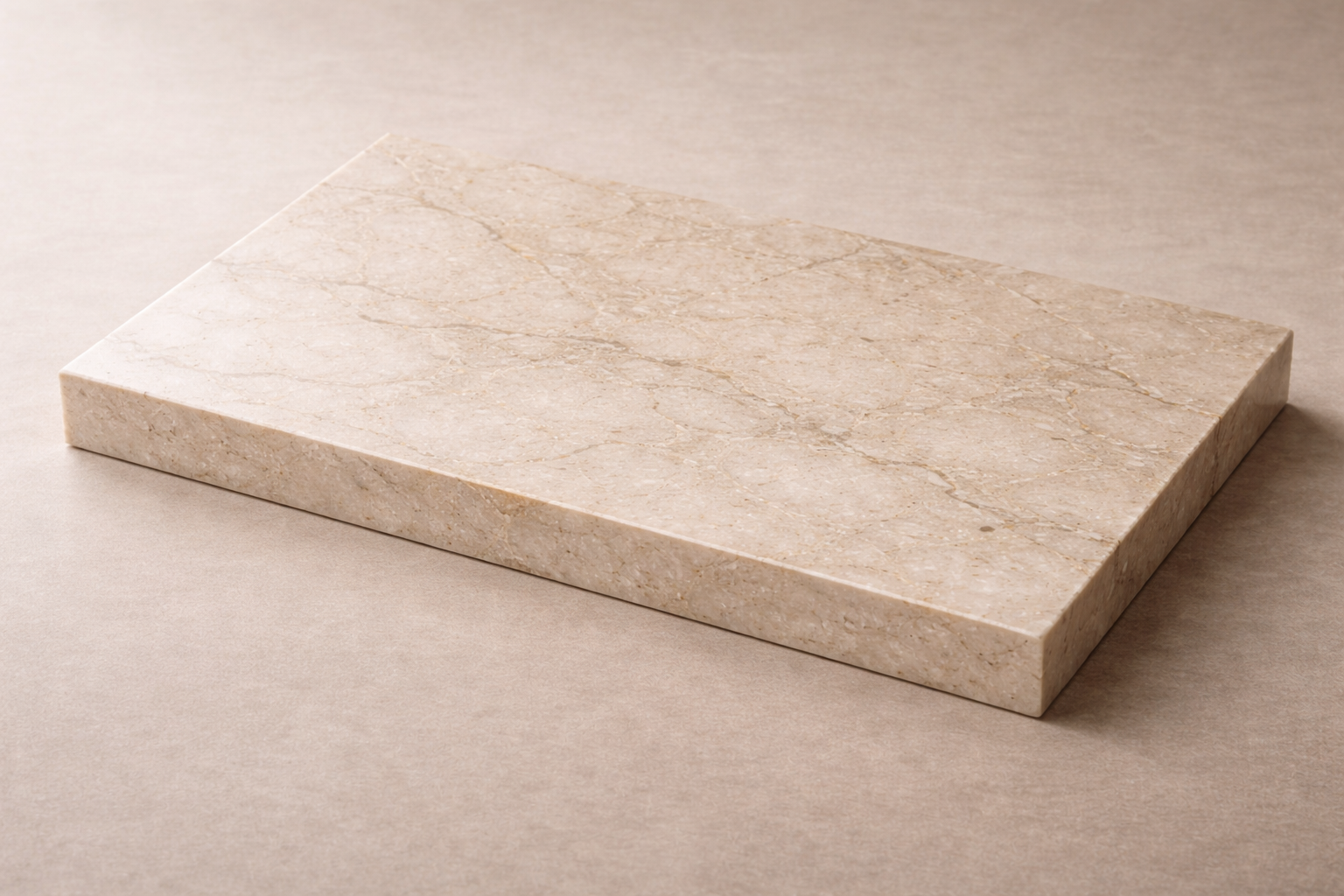 A rectangular beige marble slab with natural veining on a light beige surface.