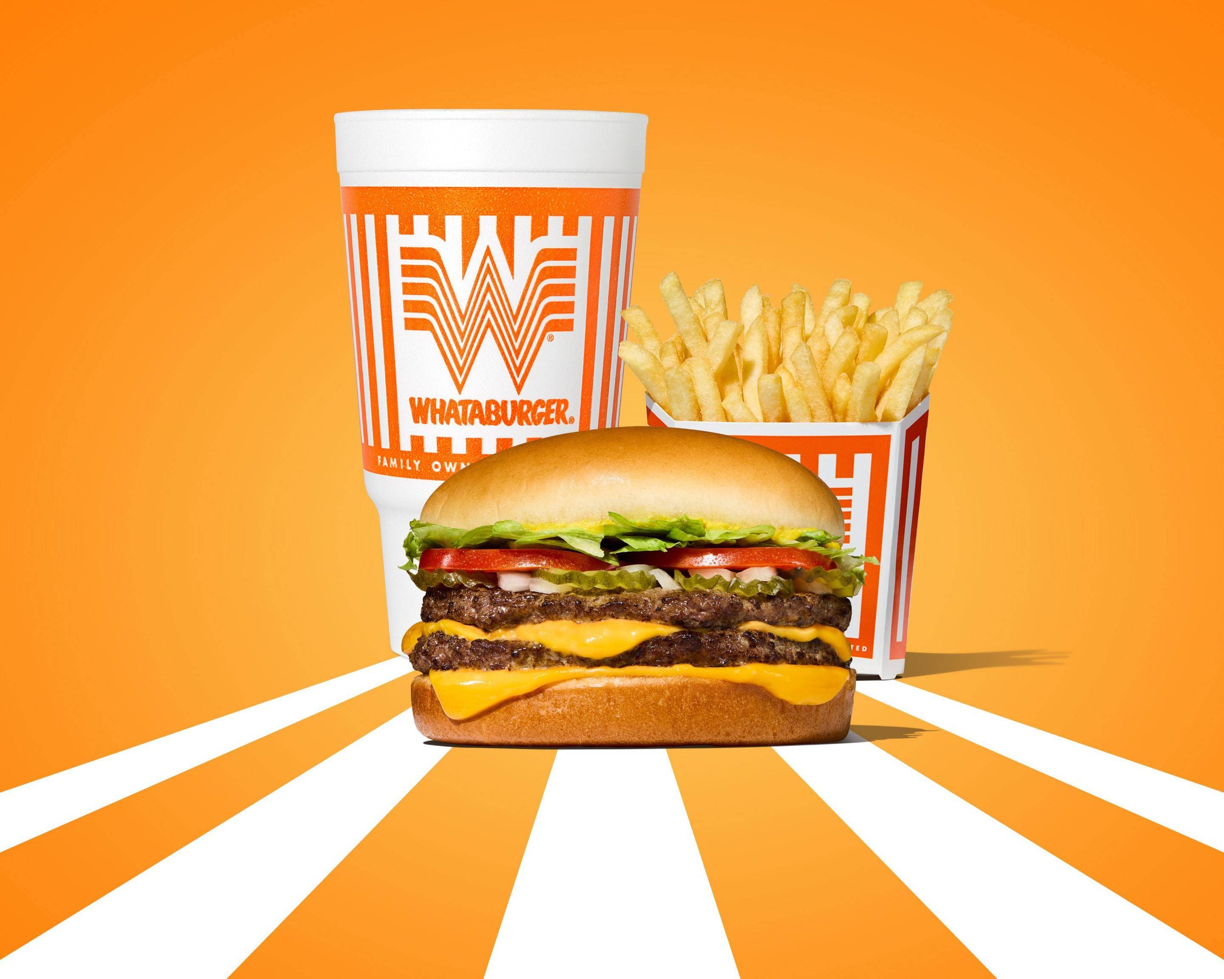 A Brickell cheeseburger with lettuce, tomato, pickles, two beef patties, and cheese in a bun, accompanied by french fries in a bucket and a large drink, all set against an orange background with white stripes.