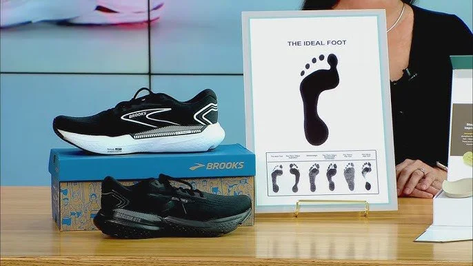 Display of athletic shoes and a diagram titled 'The Ideal Foot' showing different foot arch types at a store or exhibit.