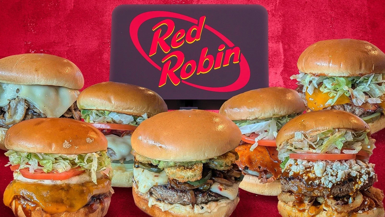 Seven burgers with various toppings and cheeses on a red surface, with a 'Red Robin' sign in the background.