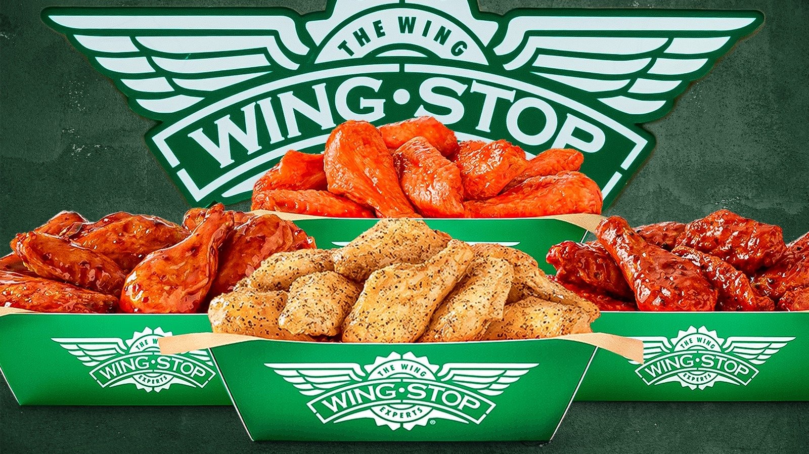 A green Wingstop food tray filled with chicken wings and tenders, with a Wingstop logo in the background.