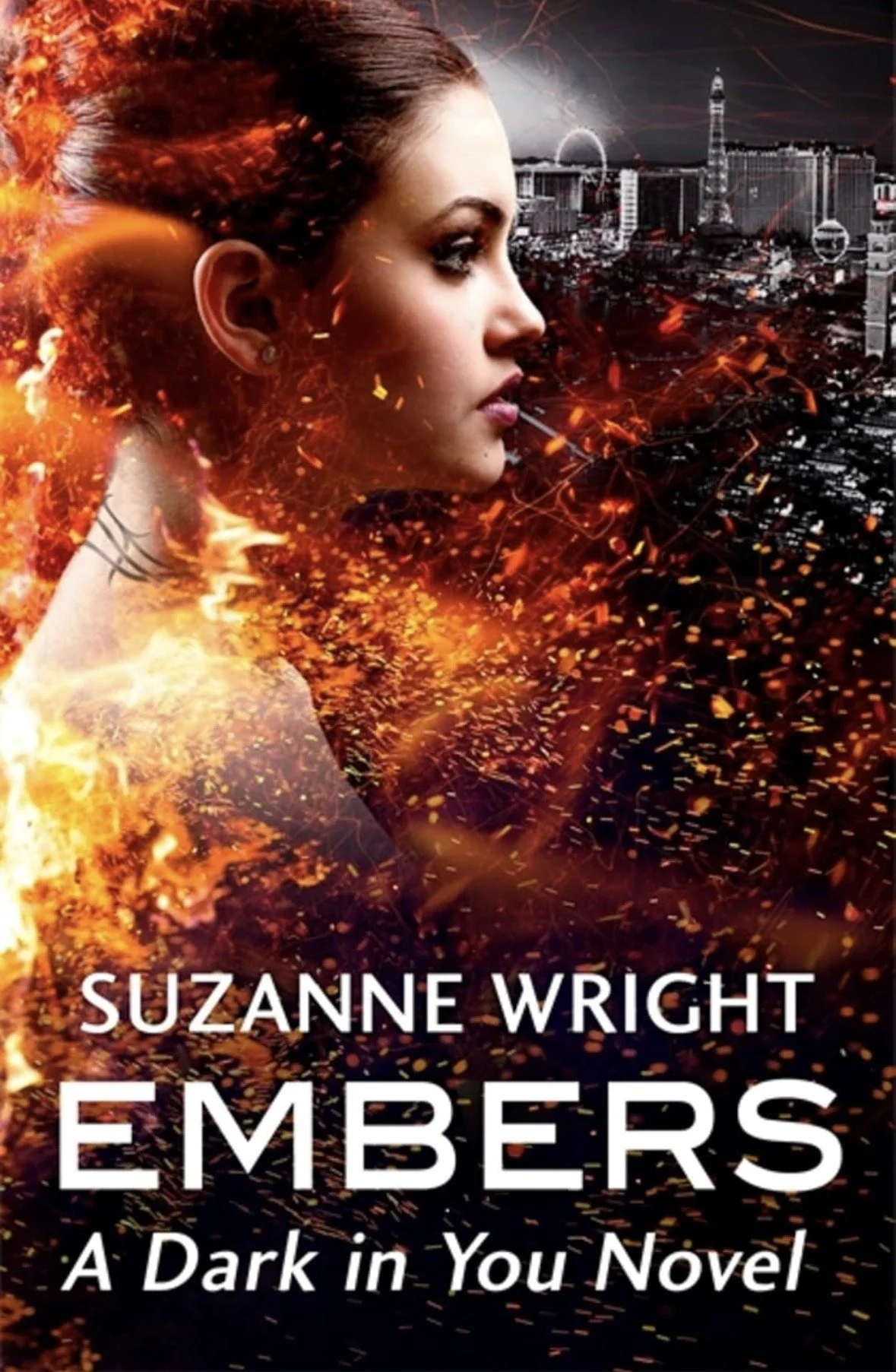 Book cover for 'Embers: A Dark in You Novel' by Suzanne Wright, featuring a woman’s profile with urban city skyline in the background, and fiery orange and yellow sparks surrounding her.