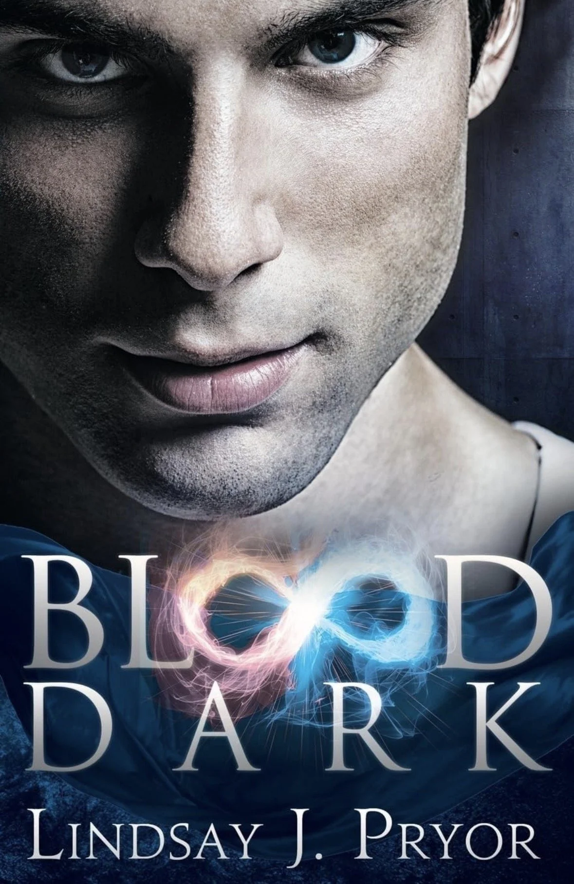 Close-up of a person's face with intense eyes, partially illuminated with a dark shadow on one side, and the book title 'Blood Dark' by Lindsay J. Pryor at the bottom with an infinity symbol made of glowing light.