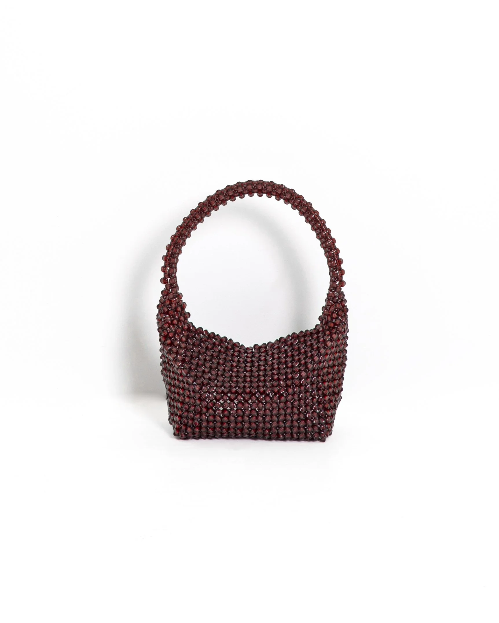 A handbag covered in small, dark red beads on a white background.