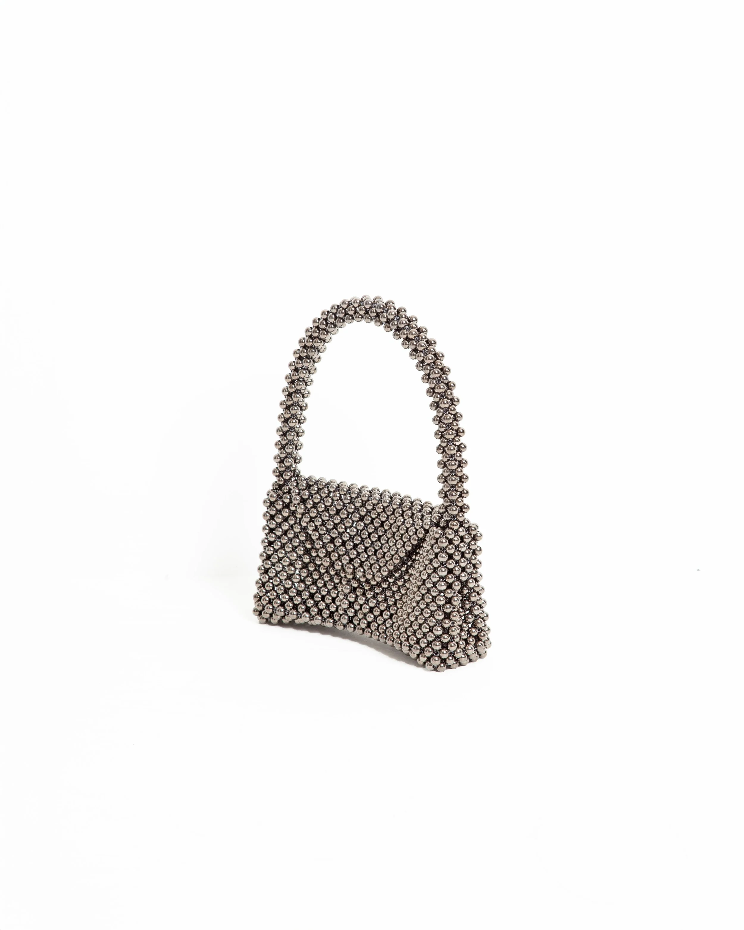 A handbag made of metallic balls arranged in a structured shape, featuring a strap and a front flap, placed on a white background.