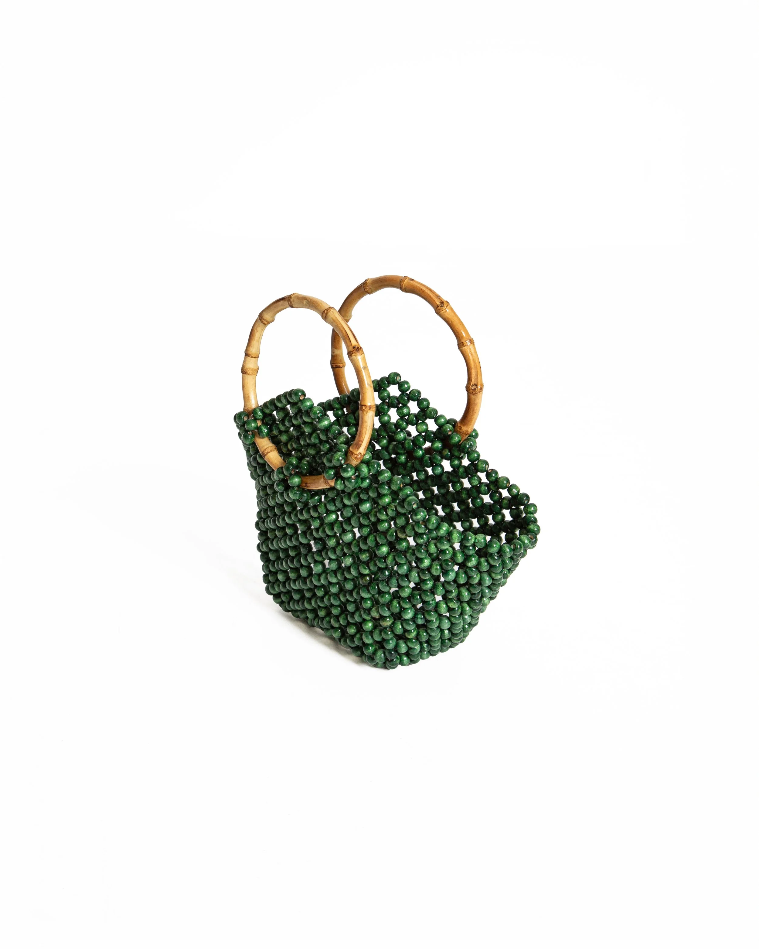 A handbag made of green beads with bamboo handles on a white background.