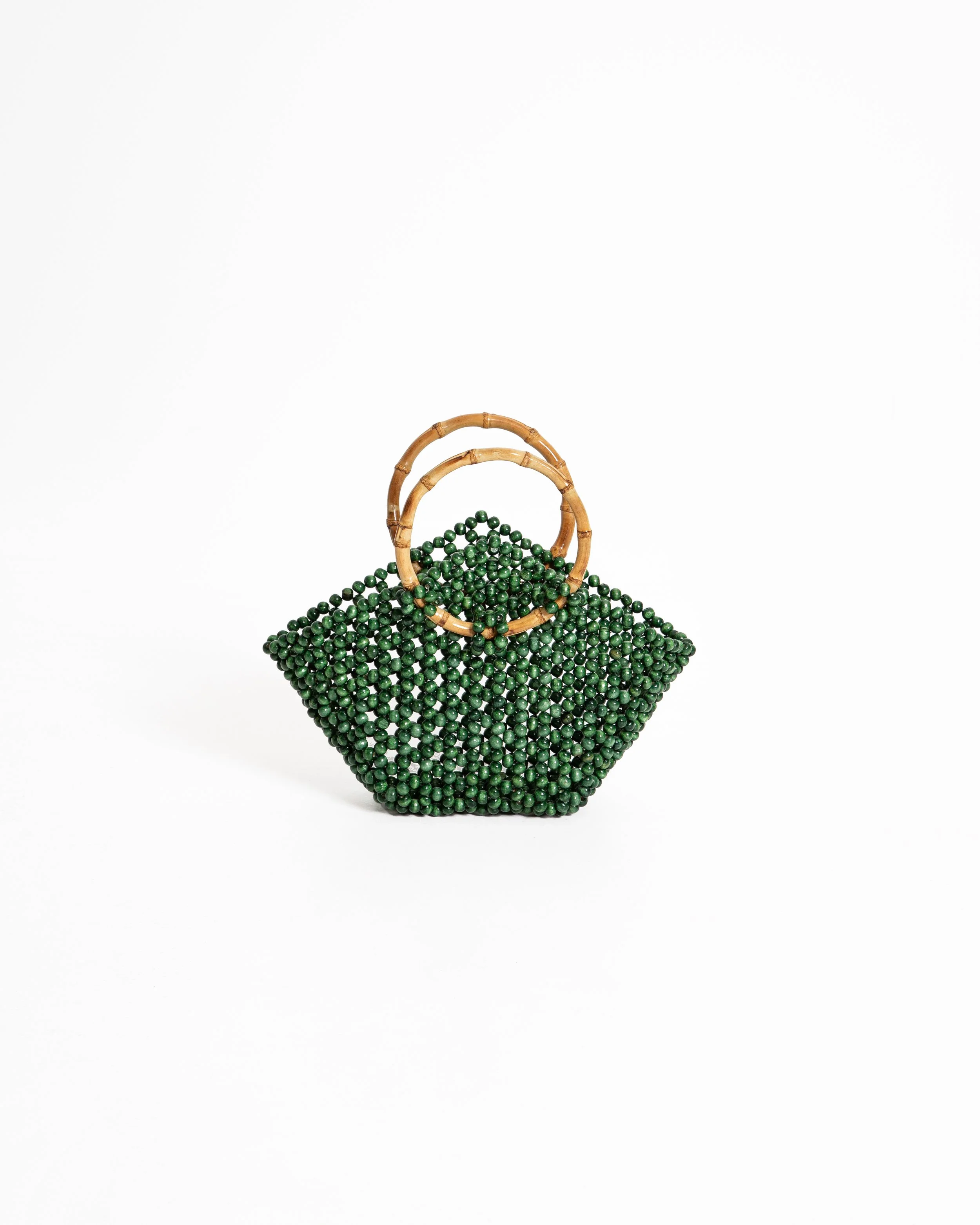 Green beaded handbag with bamboo handles on a white background.