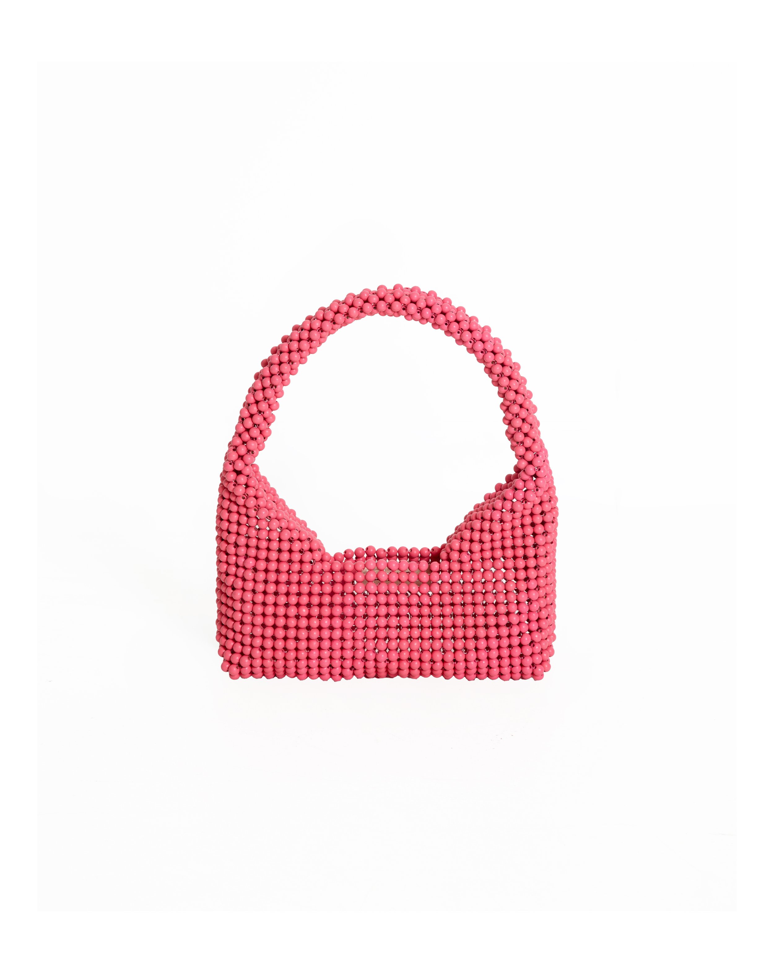 Pink handbag made of small round beads with a curved handle, displayed against a white background.
