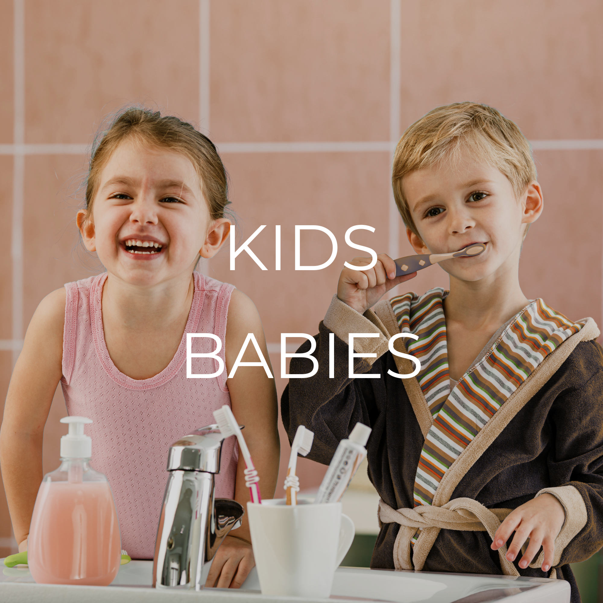 Two young children, a girl and a boy, brushing their teeth in a bathroom, with toothbrushes and a soap dispenser visible on the sink. The girl is smiling and the boy is holding a toothbrush to his mouth. The text 'KIDS BABIES' is overlaid on the image.
