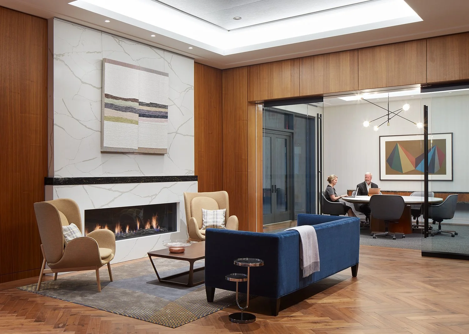 A stretched textile work and a framed blue-chip print in a confidential family office illustrating DeGroot Fine Art discreet fine art consulting and private collection management services on the homepage.