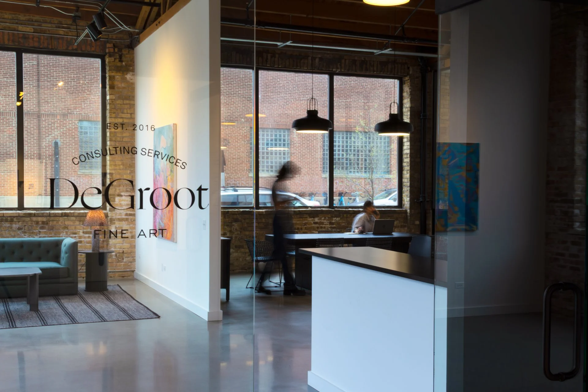 Two DeGroot Fine Art consultants collaborating at the Chicago studio illustrating the firm’s full-service fine art consulting team and company culture featured in the About section.