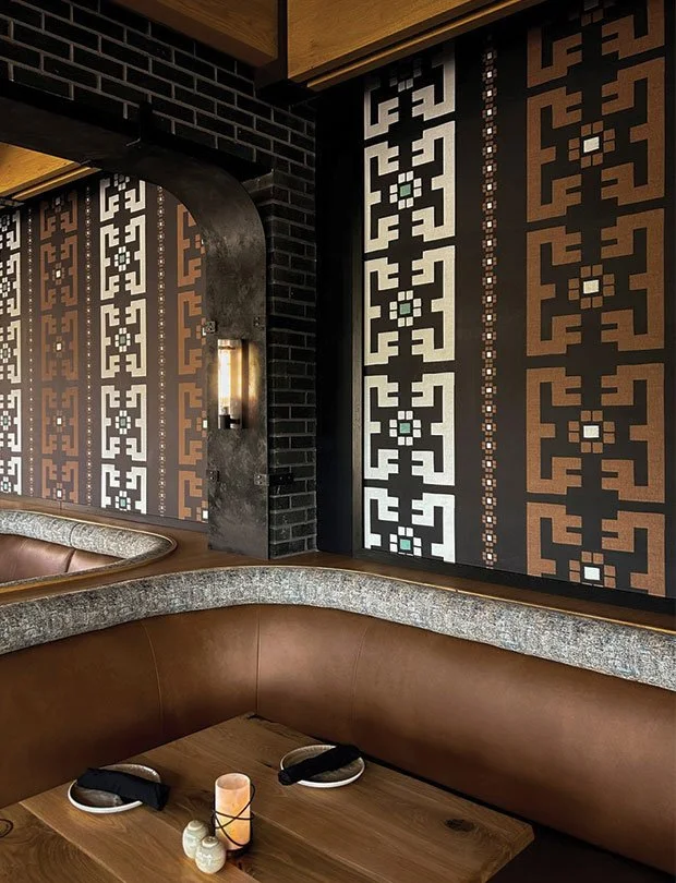 Custom artist-designed wallpaper in a hotel booth seating area illustrating DeGroot Fine Art’s fine art consulting and site-specific design services for hospitality clients.