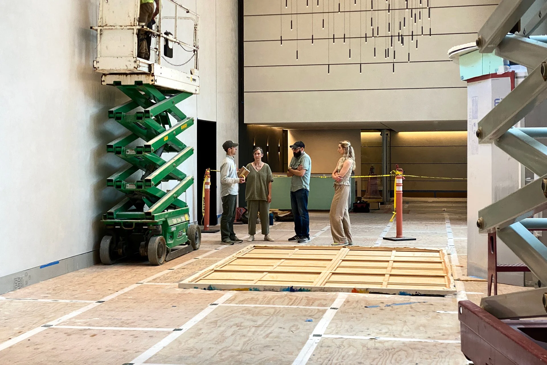 DeGroot Fine Art consultants and art handlers preparing to install a monumental painting in a new building lobby as part of fine art implementation services.