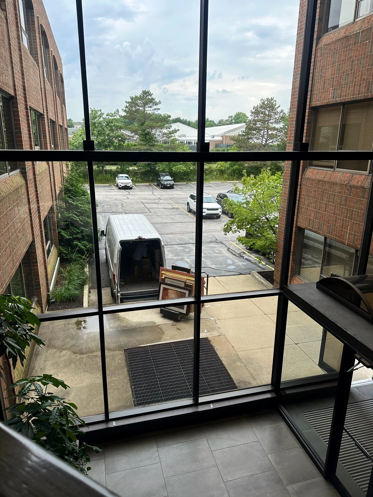 DeGroot Fine Art delivering framed artworks to a corporate headquarters loading dock as part of the acquisition and framing process.
