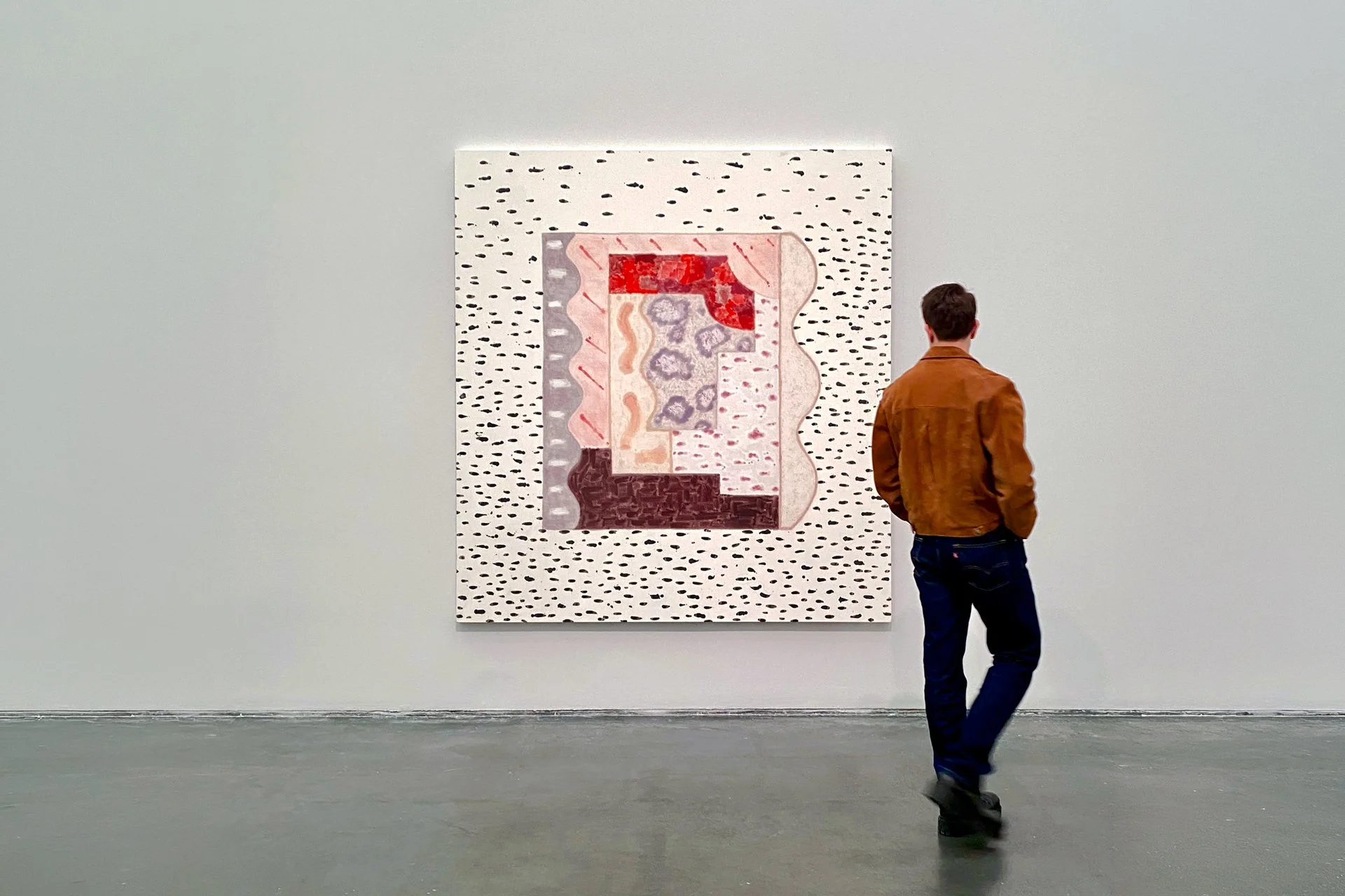 DeGroot Fine Art consultant reviewing a large painting at a gallery as part of the artwork selection process for a client collection.