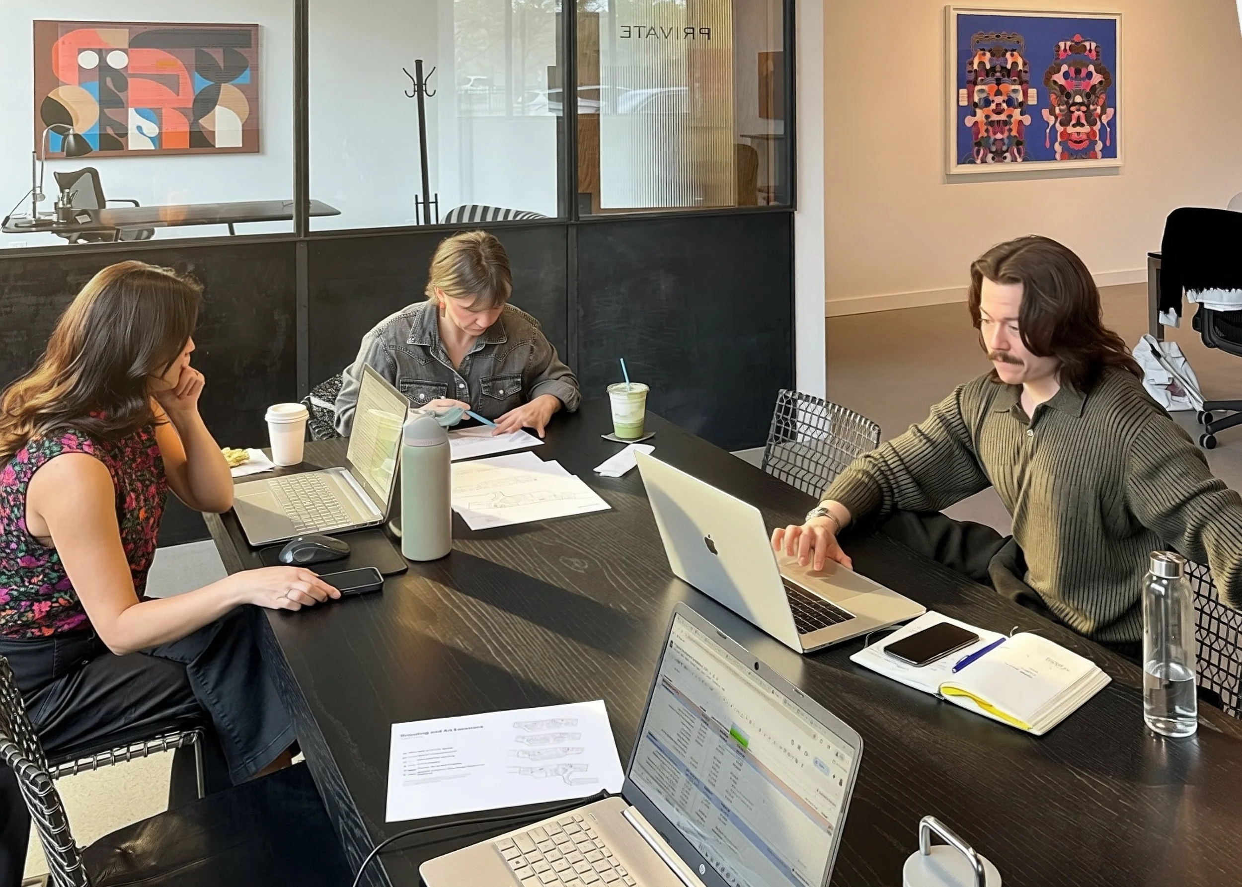 DeGroot Fine Art consultants collaborating at the studio to determine an art acquisition budget as part of the fine art consulting process.