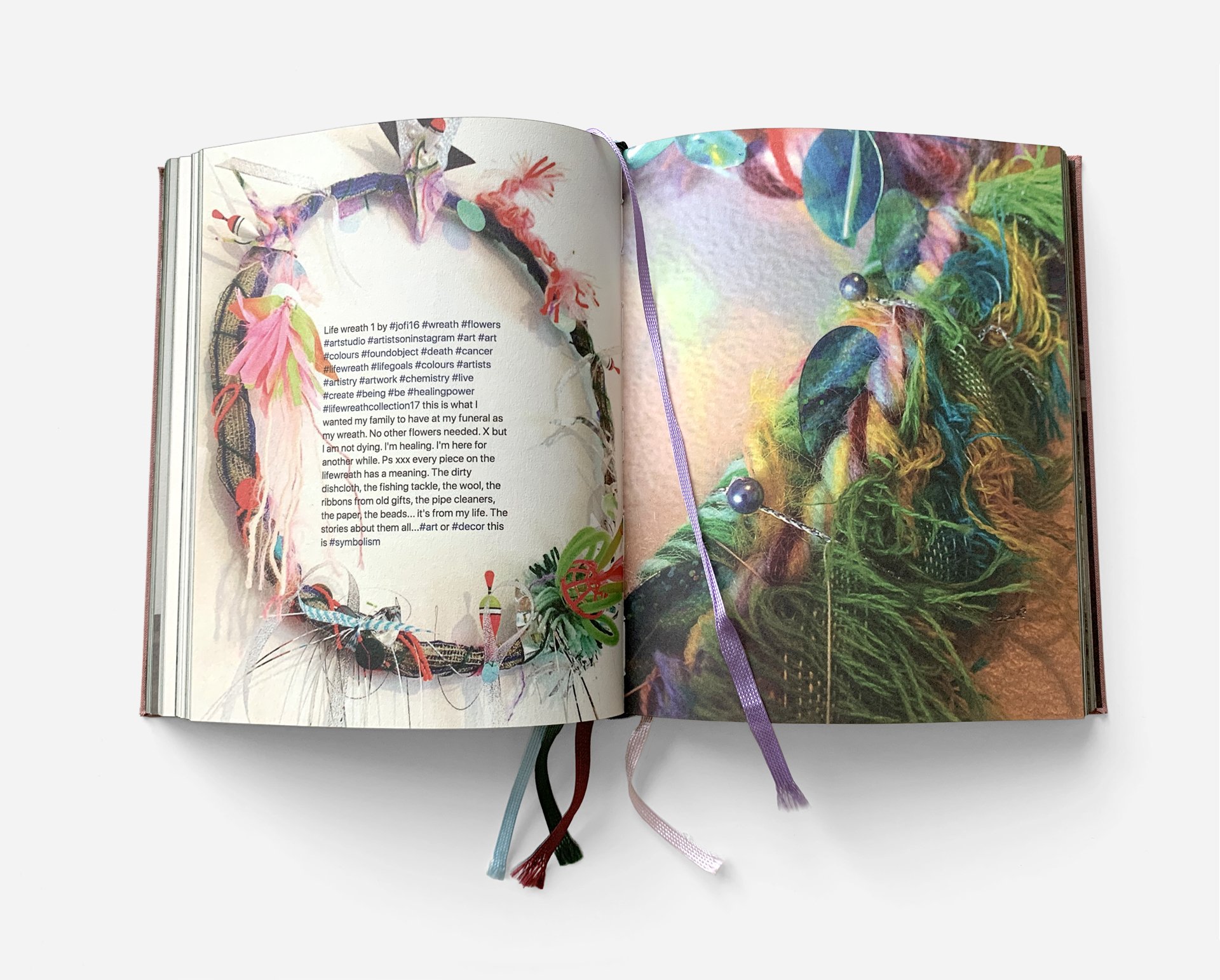 Open book showing colorful woven and textile art with ribbons and beads, ribbon bookmarks in multiple colors.
