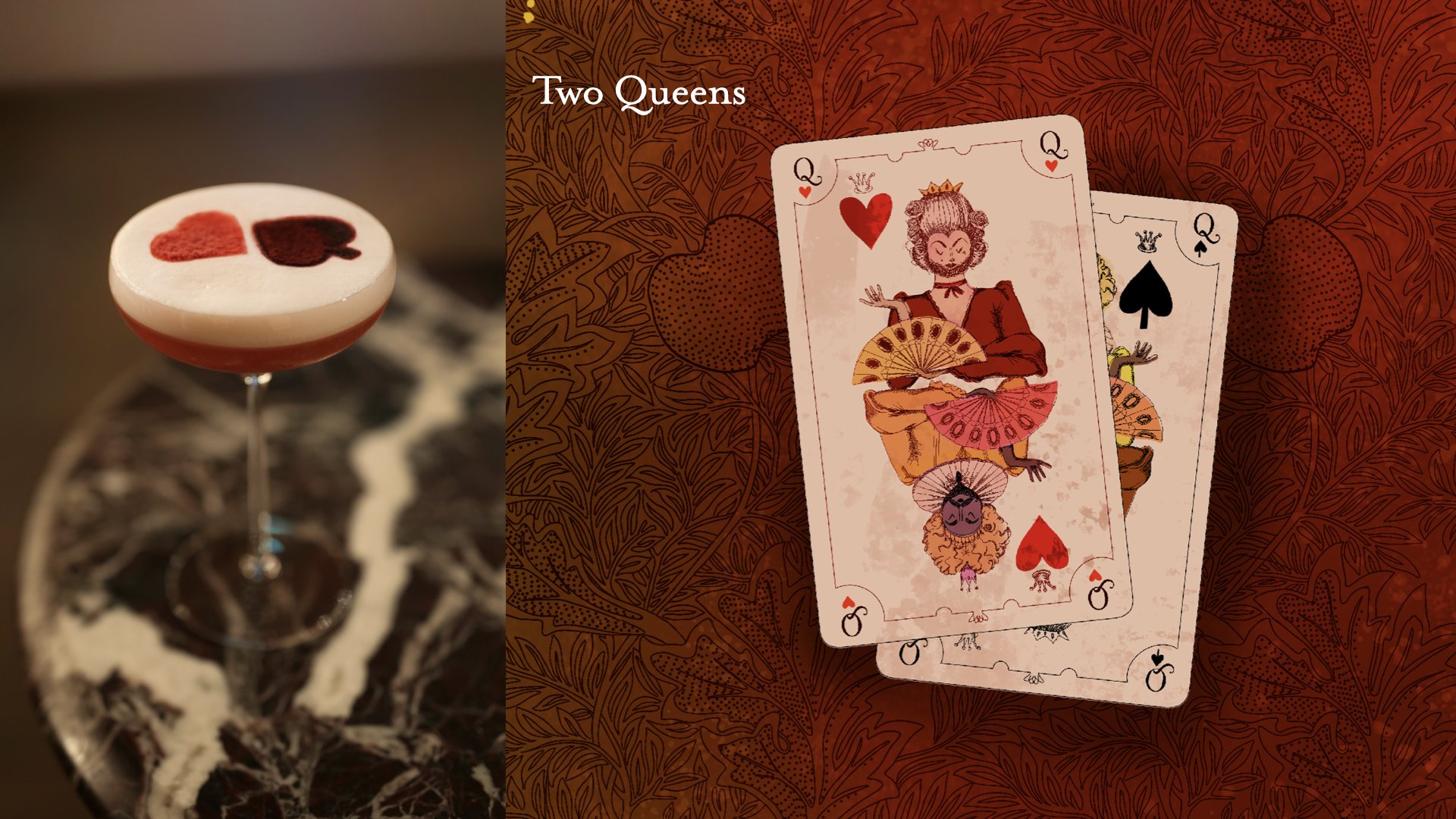 Close-up of a cocktail with a layered red and white top, featuring two heart and spade symbols in red and black. Behind is a patterned table. Next to it is a set of two Queen playing cards, the Queen of Hearts and the Queen of Spades, with stylized, 