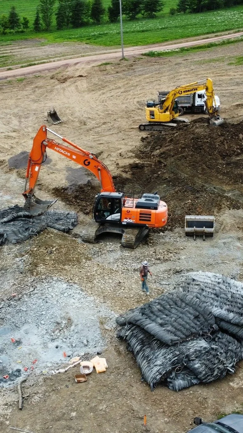 Travaux d'excavation pour la préparation de bâtiments agricoles.