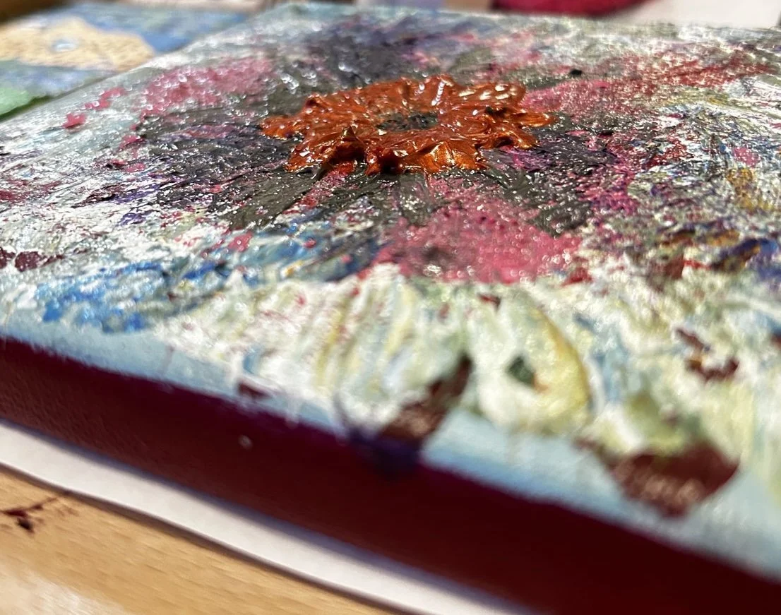 Artist at work showing the side view with texture from acrylic paint and gel