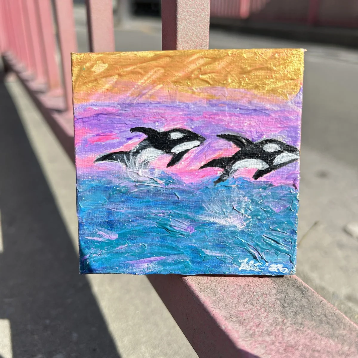2 killer whales jumping in the water is an abstract take on nature