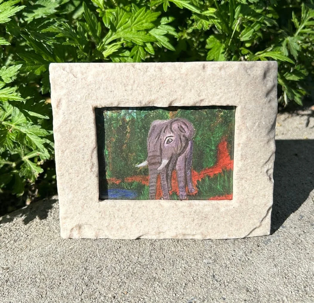 Elephant 2.5x3.5 prints in a stone frame of him in the bush walking down a trail