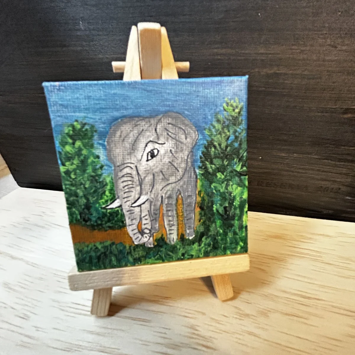 Baby elephant original painting gift resting on an easel