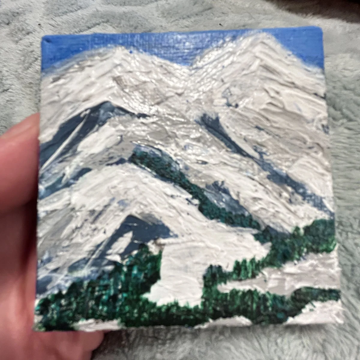 Mountains for skiing or gazing with snow and a bit of trees and grass