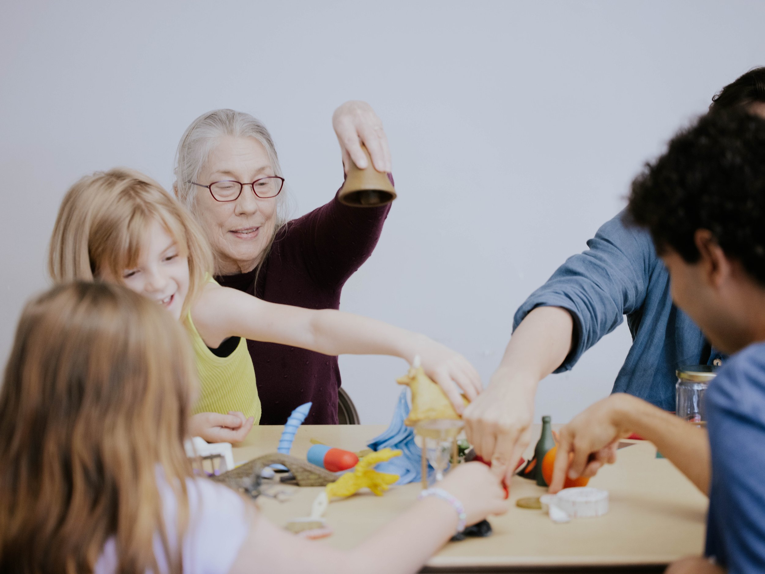 Group of adults and children playing and learning with arts and crafts