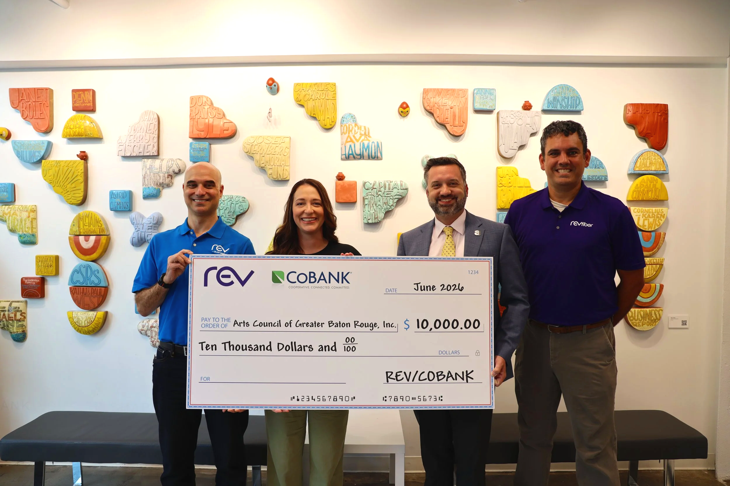 REV fiber and Arts Council of Greater Baton Rouge with donation check