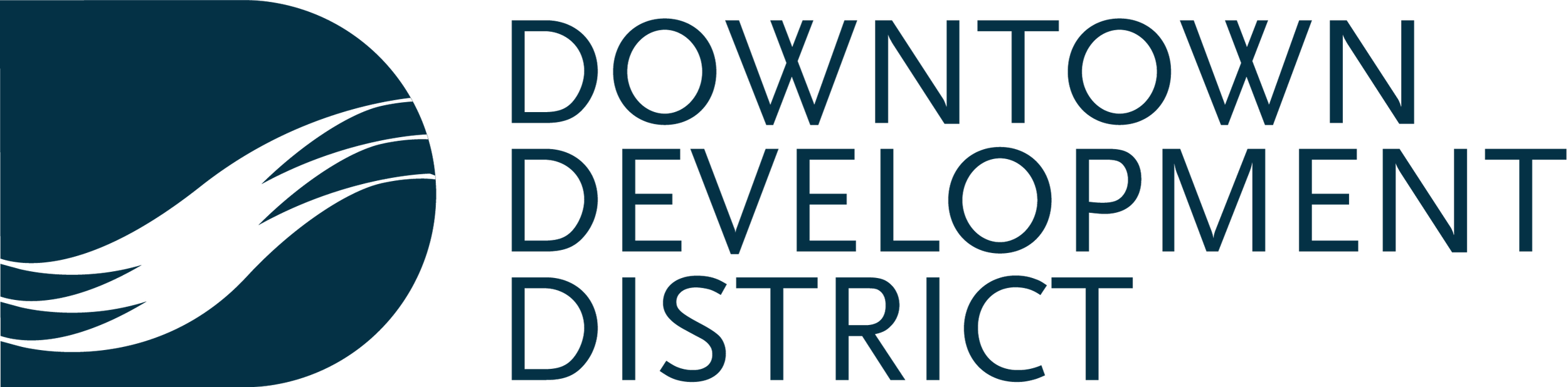 Logo of Downtown Development District featuring a stylized black wave on a blue circle with the district's name in blue text.