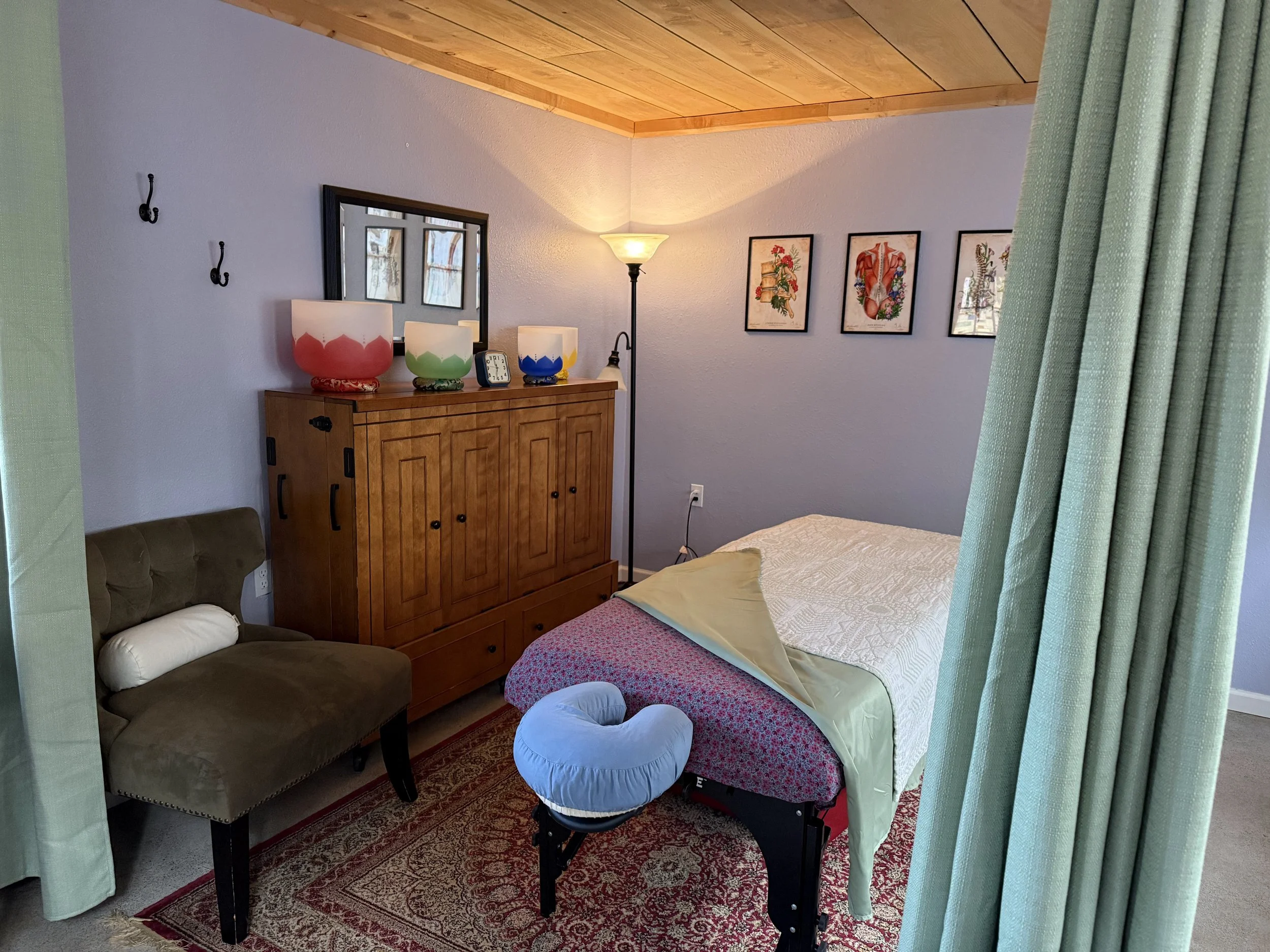 Quiet massage studio interior with warm lighting and natural materials in Corvallis